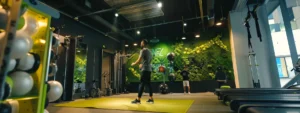 a dynamic personal training studio showcases a focused trainer demonstrating an innovative workout technique to an eager client, surrounded by high-tech fitness equipment and motivating wall graphics.